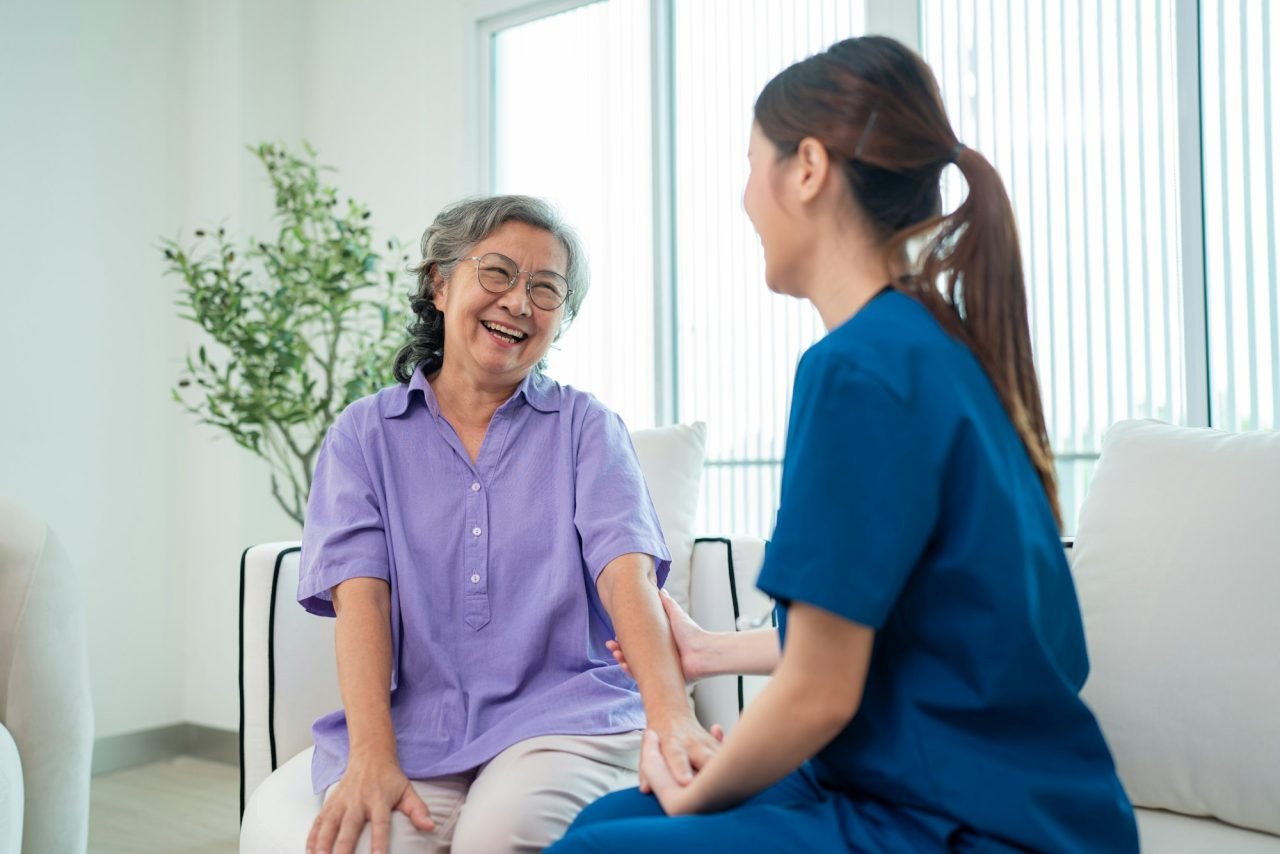 About Us One Village Health Care - Female Doctor Taking Care And Talking Mature Female Patient 1